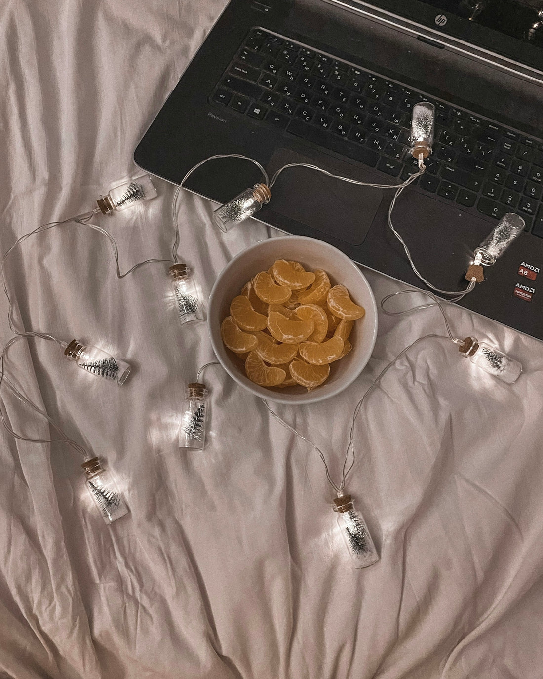 a bowl of chips sits in front of a laptop