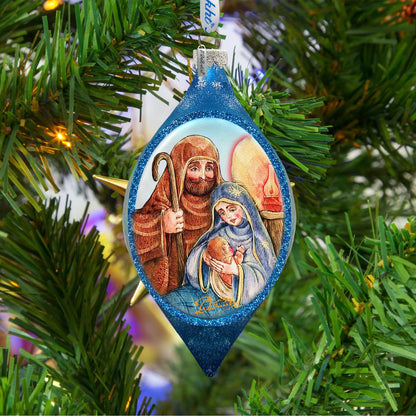 Decorative Christmas ornament with a nativity scene on a Christmas tree.