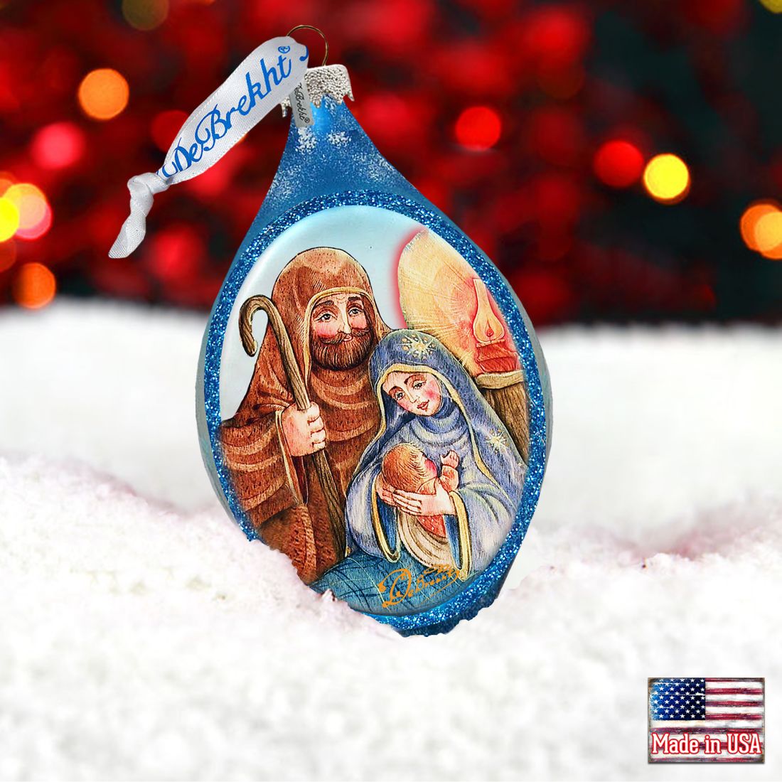 Decorative Christmas ornament with a nativity scene design, featuring a blurred festive background.