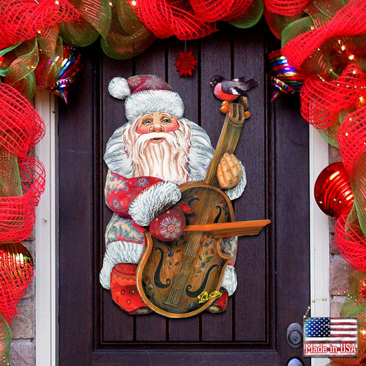 Decorative door with Santa Claus holding a violin, surrounded by red and green holiday decorations.